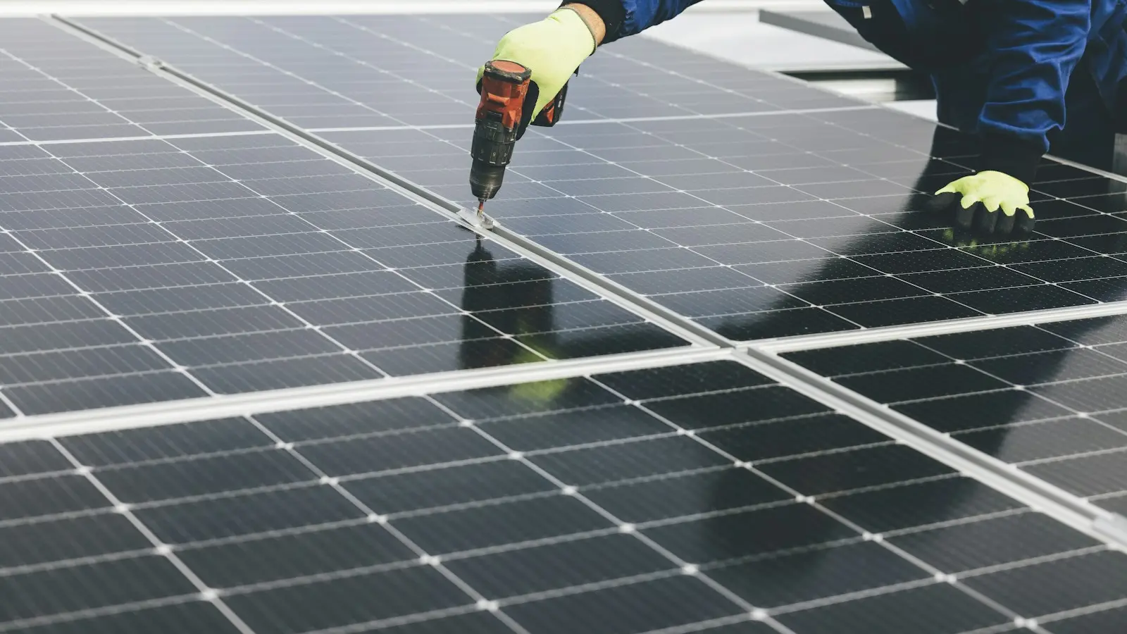 A solar technician installing photovoltaic panels
